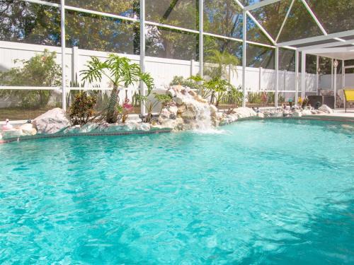 Chatham Park House | 3 Bedroom Home With Private Screened Pool With Rock Waterfall Feature And Gameroom By Florida Dream Homes
