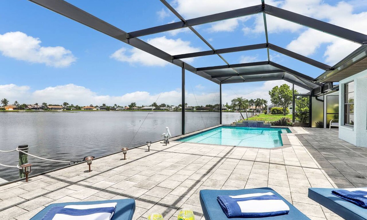 Pelican House | Escape to 80 ft Waterfront Luxury, Private Pier, Heated Pool, Jacuzzi, Bicycles!