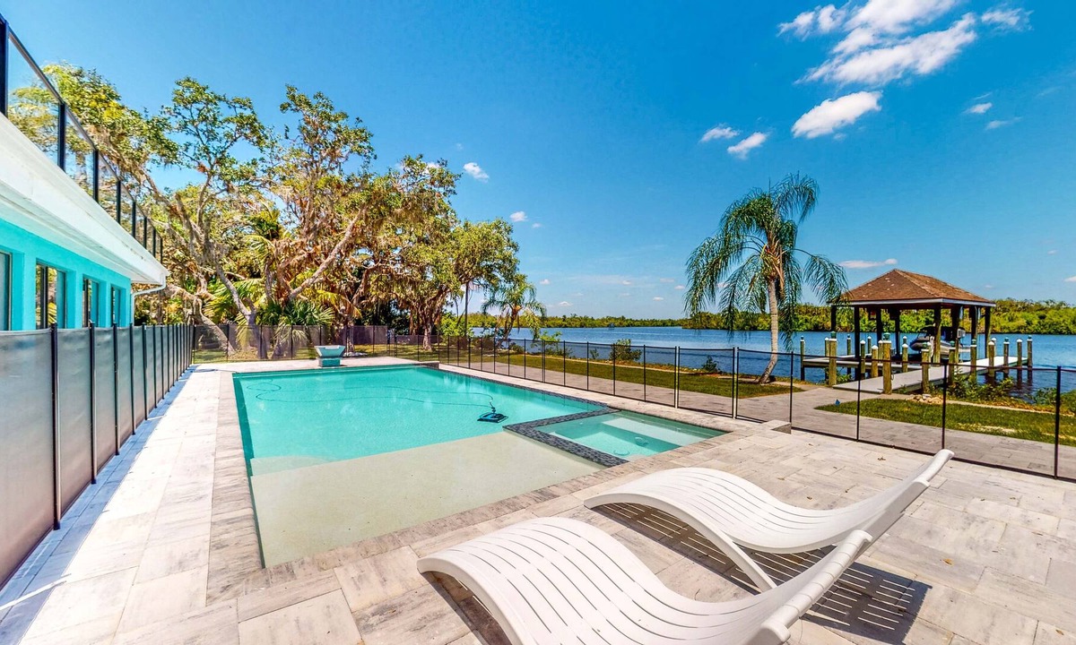 Fort Myers Shores House | Riverfront home - pool, pool spa, dock, & bikes