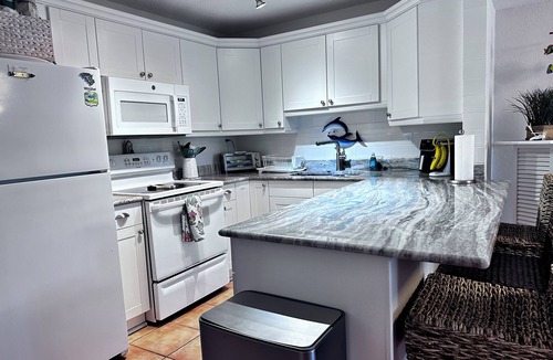 Fort Pierce Condo | 🏖️ 40 Steps to the Beach! Ground Floor Condo . Golf, Pools & Tiki Bar and more.