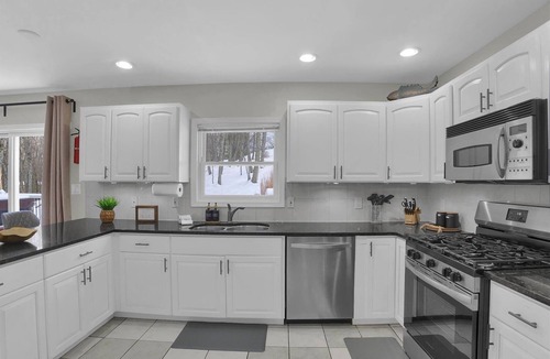 East Stroudsburg House | 4BR Poconos Retreat, Hot Tub, Movie Theater, Fire Pit, Pool Table, Arcade