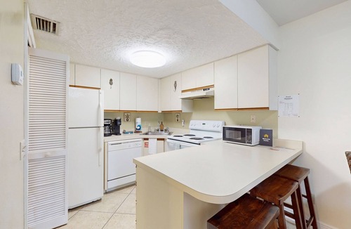 Cape Caneveral Beach Gardens Condo | Bright corner condo with shared pool, beach access, free WiFi & washer/dryer
