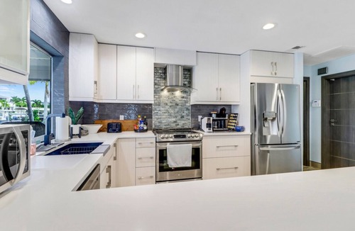 Yacht Club Villa | Coastal Paradise 1013 Modern European Style Waterfront Home w/Gourmet Kitchen & heated Pool