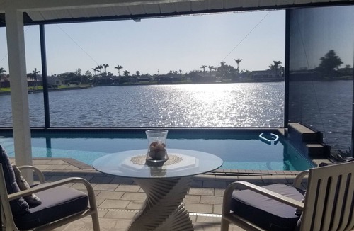 Pelican House | Escape to 80 ft Waterfront Luxury, Private Pier, Heated Pool, Jacuzzi, Bicycles!