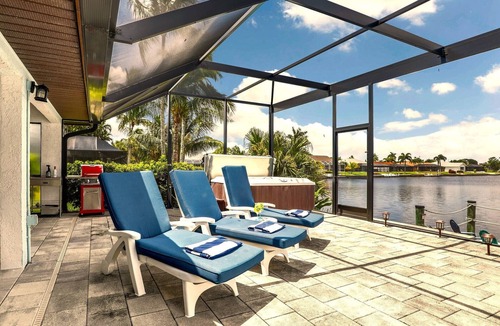 Pelican House | Escape to 80 ft Waterfront Luxury, Private Pier, Heated Pool, Jacuzzi, Bicycles!