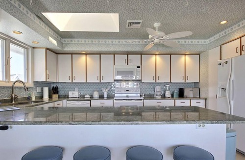 Stone Harbor House | FRIDAY TO FRIDAY RENTAL. Enjoy the beautiful sunsets - Large 2nd floor deck with pretty water views and great awnings to block the warm afternoon sun.