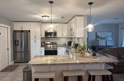 Caloosahatchee House | Gulf access pet friendly waterfront oasis with NEW heated salt water pool & spa