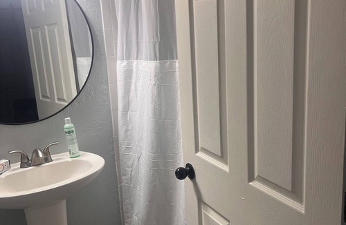 Tampa Heights House | Location Location Mini Jr. Suite. 1-bedroom queen bed behind barn doors.