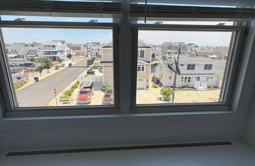 Ocean Beach III House | Luxury 6 BR Bayfront Retreat with Heated Pool, Sleeps 14, Minutes to Beach