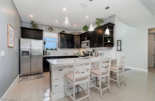 Trafalgar House | Paradise of Cape Coral on Canal, with Heated Pool, Tiki Hut Grill & Elec Bikes