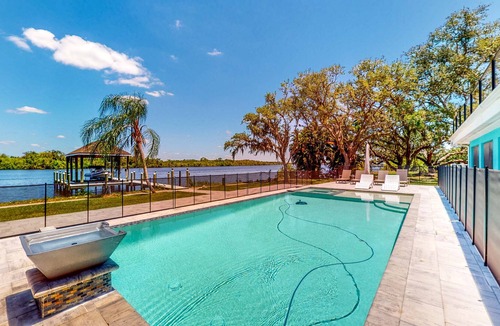 Fort Myers Shores House | Riverfront home - pool, pool spa, dock, & bikes