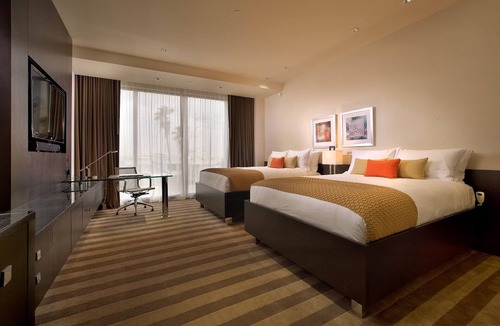Seybold Hotel | Two Convenient Rooms with Large Glass Window and Outdoor Pool