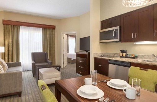 Feather Sound Hotel | Unwind and Indulge In Our Oasis! Outdoor Pool, Free Breakfast, Full Kitchen!