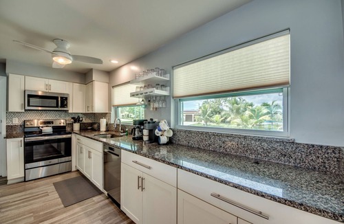 Caloosahatchee Villa | Villa Tropical Vibes - Charming 3 BR waterfront Villa with heated pool, bicycles, fishing poles - walking distance to bars and restaurants