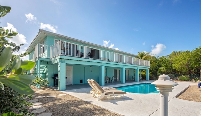 Canal-front, dog-friendly home with heated pool, seawall dock & grill