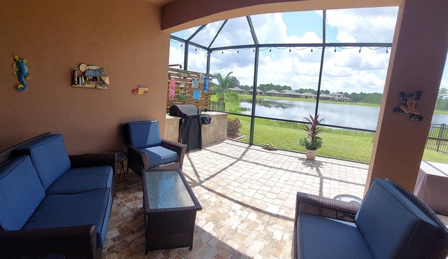 Lake view home with a screened outdoor entertainment area.