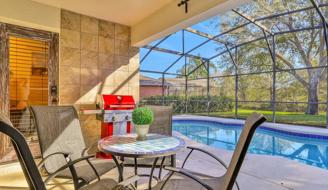 Peaceful home with an enclosed patio, pool, grill, washer/dryer, & AC