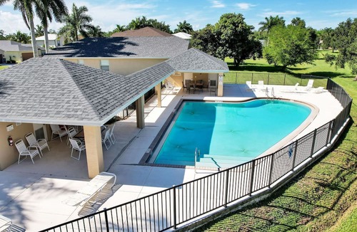 Biggar House | Gated Oasis: Luxurious 5-BR Retreat in Ft. Myers